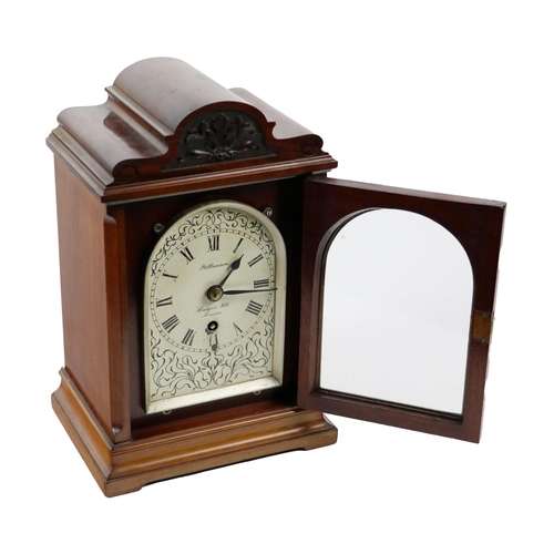 865 - A late Victorian mahogany cased Mantle Clock, with shaped top and relief carving, above an arched pa... 