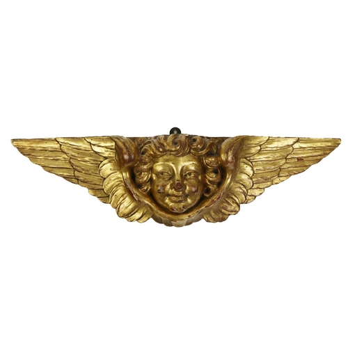 881 - A 19th Century  carved giltwood Overdoor, modelled as a cherub head issuing wings, approx. 58cm... 