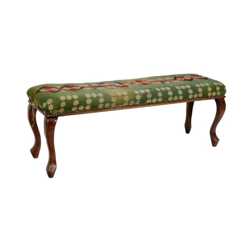 938 - A Victorian oblong walnut Footstool, with green ground needlework fabric, covering on cabriole legs,... 