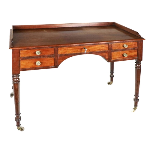 942 - A 19th Century mahogany kneehole Dressing Table, with half gallery back over a frieze with central d... 