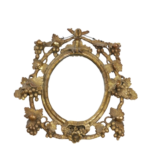 961 - An attractive 19th Century giltwood oval Wall Mirror, decorated in pierced design with vine leaves a... 