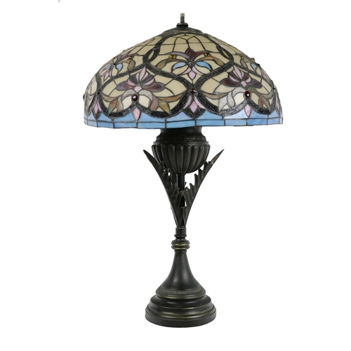 1013 - A Tiffany style stained glass Lamp, with domed shade of cream, blue and pink colouring, on a tubular... 