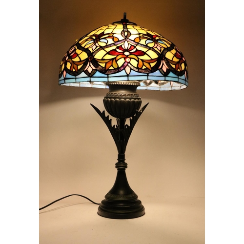 1013 - A Tiffany style stained glass Lamp, with domed shade of cream, blue and pink colouring, on a tubular... 