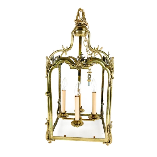 1017 - A 19th Century ornate brass Hall Lantern, with leaf decorations and four panels (lacks glass) approx... 