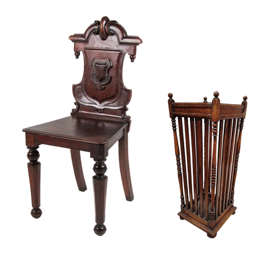 682 - A Victorian mahogany shield back Hall Chair, with carved back over solid seat on front octagonal tap... 