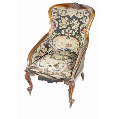 983 - A Victorian rosewood Nursing Chair, the shield back with carved floral relief covered in needlework ... 