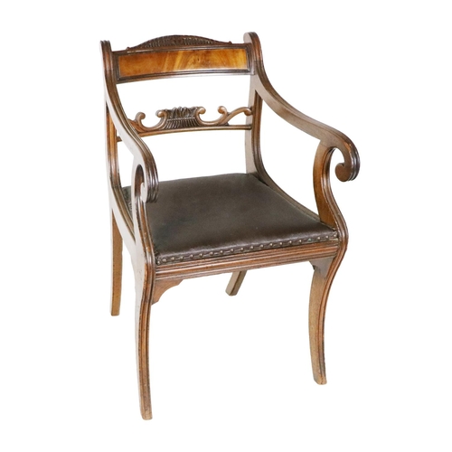 985 - A Regency mahogany Carver, with solid top rail and upholstered seat, scrolling arms and sabre legs. ... 