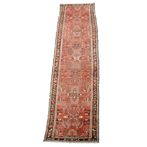 429 - A semi-antique Middle Eastern woollen Carpet Runner, the burgundy ground multi-floral centre inside ... 