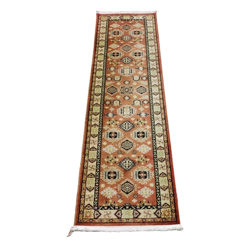 432 - A modern Middle Eastern style Runner Carpet, the centre panel with geometric design with narrow bord... 