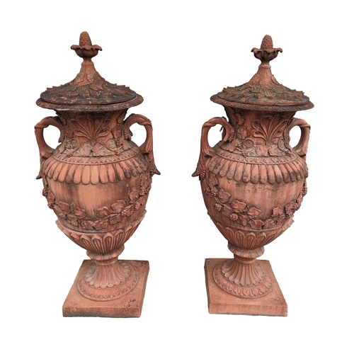 449 - A pair of attractive large terracotta Urns and covers, of classical design, each cover with leaf des... 