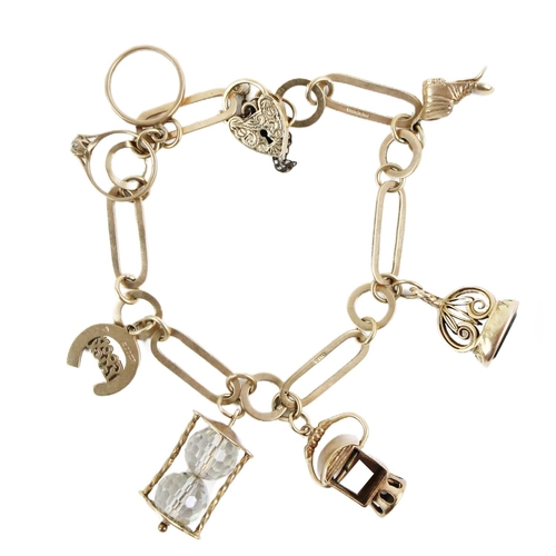 1112 - A 9ct gold long shaped link Charm Bracelet, with love heart shaped clasp, and 6 charms, including ol... 