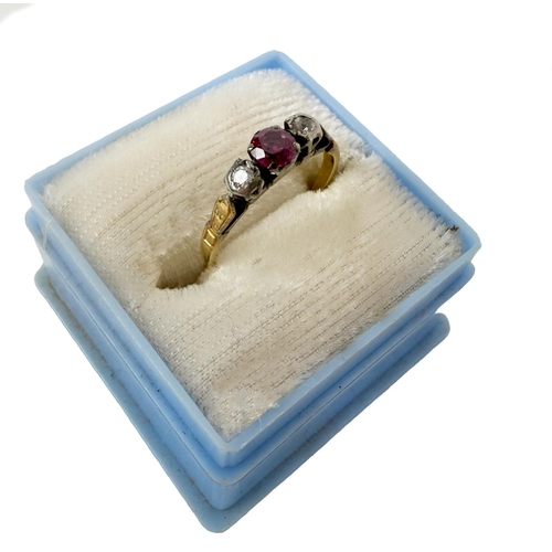 1115 - A gold Ladies Ring, with central ruby type stone flanked with diamonds either side, ring size approx... 