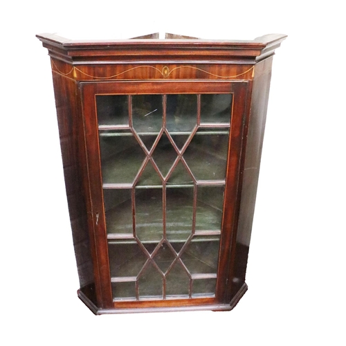 27 - A 19th Century mahogany Hanging Corner Cabinet, the shaped cornice over inlaid frieze above an astra... 