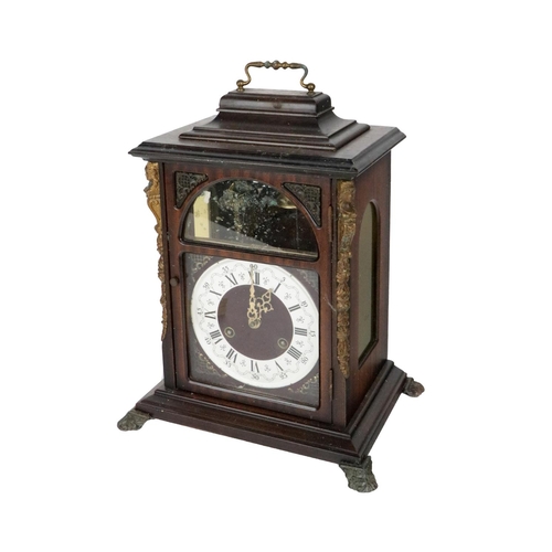 7 - A Georgian style mahogany Bracket Clock, with brass carrying handle, the face with exposed chime abo... 