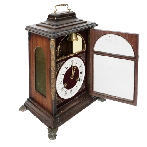 7 - A Georgian style mahogany Bracket Clock, with brass carrying handle, the face with exposed chime abo... 