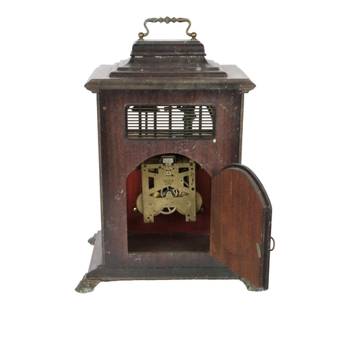 7 - A Georgian style mahogany Bracket Clock, with brass carrying handle, the face with exposed chime abo... 