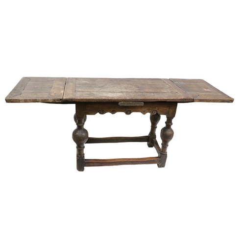 316 - A fine antique oak draw-leaf plank top Dining / Refectory Table, with shaped frieze on four baluster... 