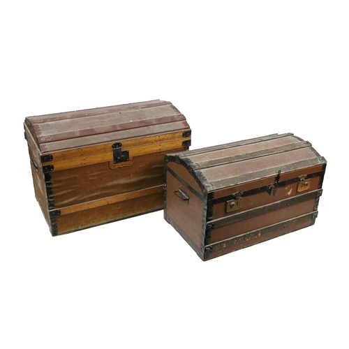 500 - A large domed top Trunk, with two carrying handles and brass lock; together with a smaller ditto, as... 