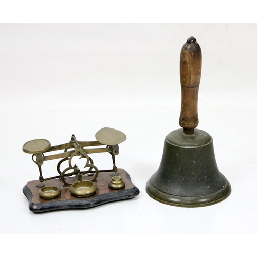 509 - A wooden handled and brass School Bell; together with a brass Weighing Scales. (2)... 