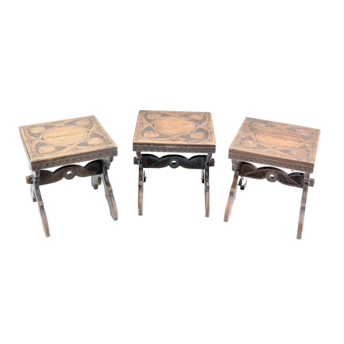 516 - A set of 3 Medieval style carved X framed walnut Stools. (3)