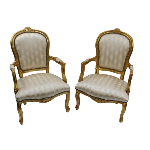 537 - An attractive pair of Louis XVI style giltwood Fauteuils, with floral motif with padded back and sea... 