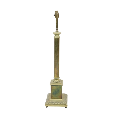 556 - A heavy brass pillar Table Lamp, on a decorated plinth base. (1)