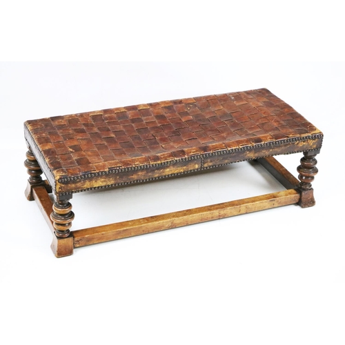 581 - An oblong leather covered Footstool, on walnut frame, 32 1/2