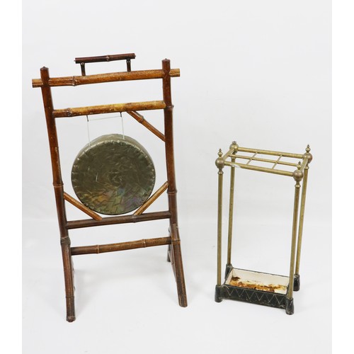 502 - An assimilated bamboo framed Dinner Gong, with carrying handle; together with a brass Stick or Umbre... 