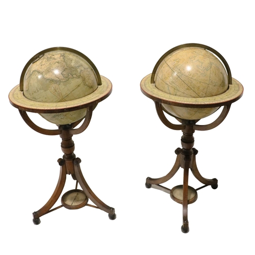A highly important and rare pair of large early 19th Century Terrestrial and Celestial Globes on Stands, by John and William Newton, London 1818, each with shaped circular brass support bars, printed borders and spherical well, turned pillar support on three outsplayed legs, united by a stretcher with central stretcher, on ebonised ball feet, each approx. 102cms (40") high. (2)