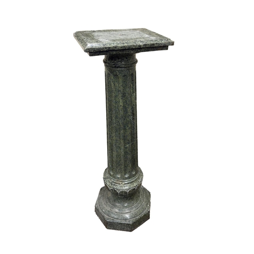 726 - A large 19th Century carved Connemara marble Plinth, with moulded rectangular top above a reeded col... 