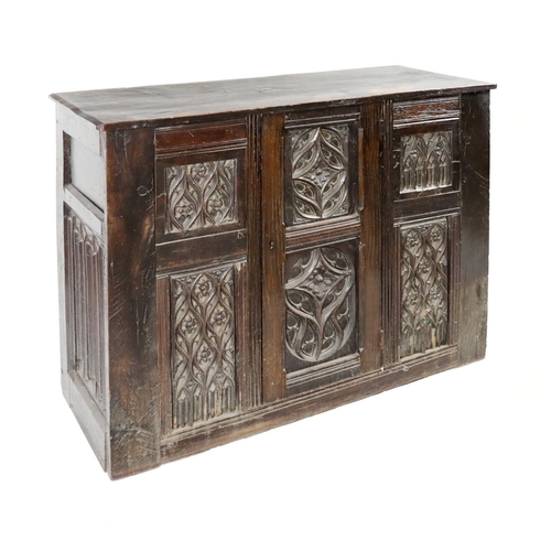 813 - An 18th Century English oak Larder Cupboard, with Gothic style double carved paneled door with four ... 