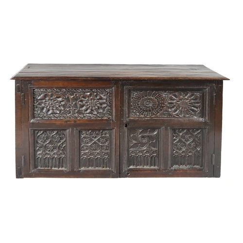 813 - An 18th Century English oak Larder Cupboard, with Gothic style double carved paneled door with four ... 