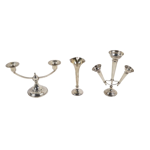 36 - Silverware: An American silver two branch Candelabra, on circular base (weighted) approx. 13cms high... 