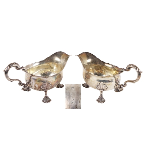122 - A fine pair of heavy English Georgian silver Sauceboats, with shaped edge, scroll handles, engraved ... 