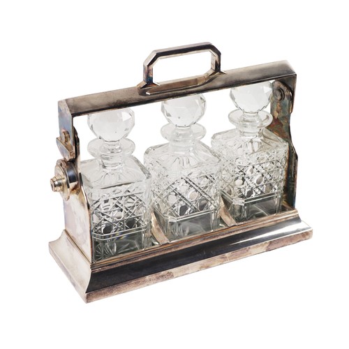 44 - A fine quality silver plated Tantalus, with three cutglass decanters and stoppers, with carrying han... 
