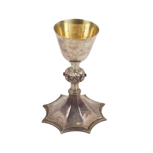 46 - A 20th Century Irish silver Gothic style Chalice, the plain bowl with gilded interior, shaped pillar... 
