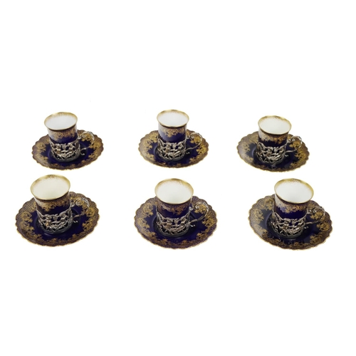 1003 - A small Ansley china set of 6 Coffee Cups, with embossed and pierced silver holders and 6 matching s... 