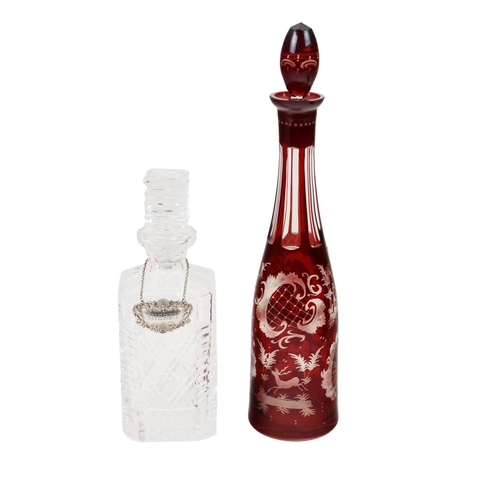1005 - A fine quality tall crimson glass Bottle Decanter and stopper, with etched floral trestle and buildi... 
