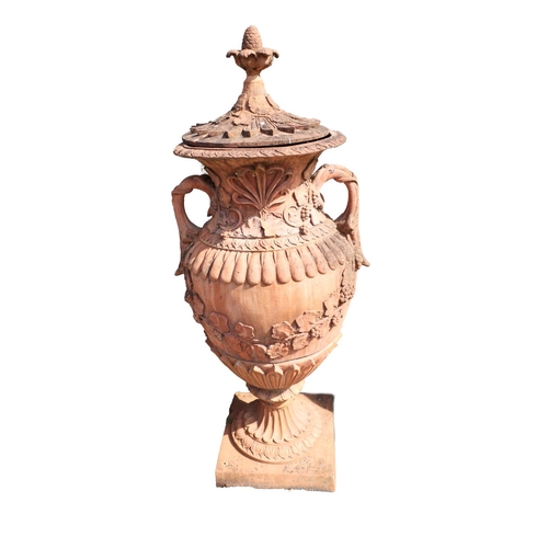 21 - An impressive pair of terracotta coloured composition stone Garden Urns, each relief moulded with sc... 