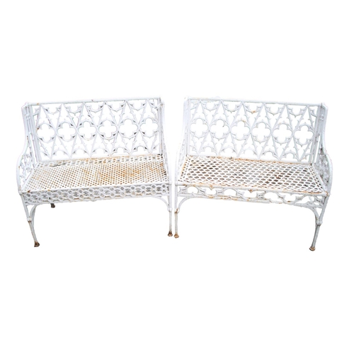 A very good pair of old cast iron Gothic Revival two seater Benches, from the Val D'Osne foundry, each back with typical Gothic tracery above honeycomb seats under arched arm panels, each approx. 100cms (39") wide. (2)