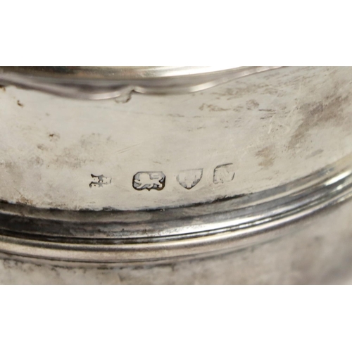 20 - An English silver Teapot, the hinged top with gadroon border, S scroll ebonised handle, on circular ... 
