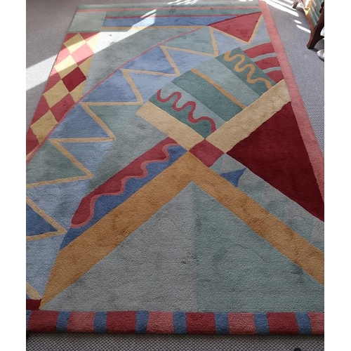 13 - A fine wool rug of geometric design by Mc Murray of Moyard, Co. Galway, 242 x 155 cms.