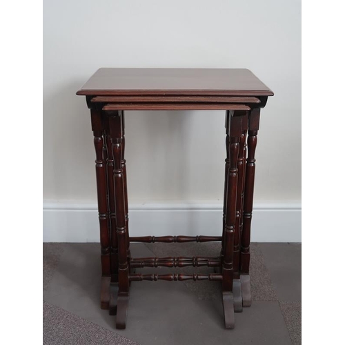 16 - A nest of three mahogany tables, the rectangular tops raised on turned supports and splayed feet, 50... 