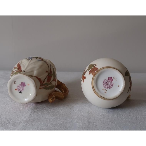 20 - A pair of Worcester floral decorated and gilded jugs bird beak creamers, 9.5 cms high.