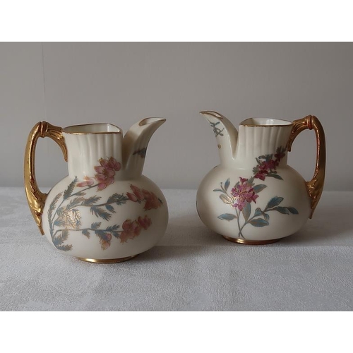 21 - A pair of Worcester floral decorated and gilded jugs, 9.5 cms high.