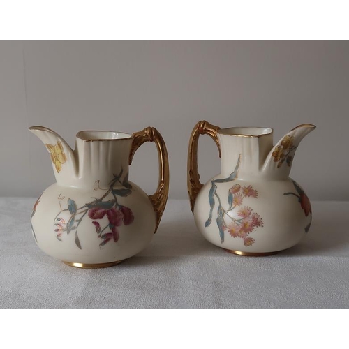 21 - A pair of Worcester floral decorated and gilded jugs, 9.5 cms high.