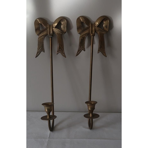 23 - A pair of Edwardian style brass wall sconces with ribbon motifs, 40 cms high.