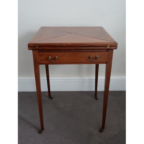 5 - An Edwardian inlaid mahogany envelope card table with frieze drawer raised on tapering supports, 56 ... 