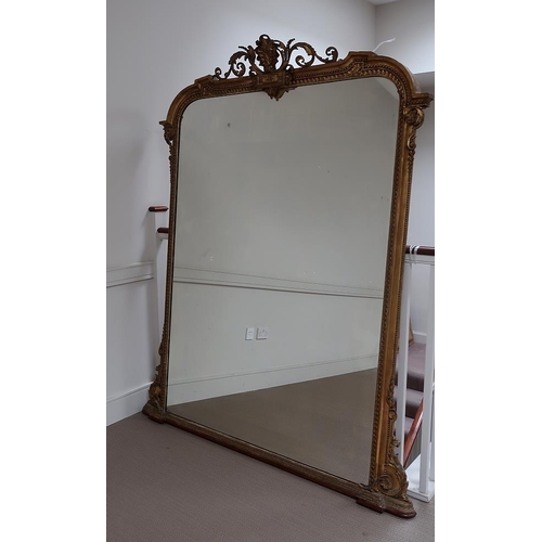 51 - A Victorian giltwood mirror, the rectangular frame with scroll crestings flanked by scrolls and bead... 