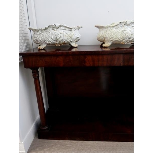 52 - A mid 19th century mahogany consul table the rectangular top above doric column supports raised on p... 